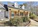 Inviting front porch with rustic wood columns and charming decor, creating a welcoming entrance at 950 Besse Way, Locust Grove, GA 30248