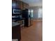Traditional kitchen featuring stainless steel appliances and light wood-look flooring at 950 Besse Way, Locust Grove, GA 30248