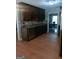 Traditional kitchen featuring wood cabinets and stainless appliances with light wood-look flooring at 950 Besse Way, Locust Grove, GA 30248