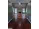 Bright living room with hardwood floors, fireplace, and door to backyard at 950 Besse Way, Locust Grove, GA 30248