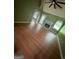 Bright living room featuring a fan, hardwood floors, a fireplace, and natural lighting at 950 Besse Way, Locust Grove, GA 30248