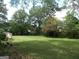 Lush green backyard with mature trees and a well-maintained lawn at 1253 Gatewood Drive Dr, Lawrenceville, GA 30043