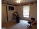 Bedroom with a window, shelving above, and carpeted floors at 1253 Gatewood Drive Dr, Lawrenceville, GA 30043
