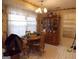 Cozy dining room with a wooden table, vintage hutch, and ample natural light, perfect for Gathering meals and entertaining at 1253 Gatewood Drive Dr, Lawrenceville, GA 30043