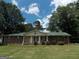 Charming brick ranch-style home with a green metal roof and well-manicured lawn at 1253 Gatewood Drive Dr, Lawrenceville, GA 30043