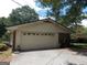 Attached garage with brick and siding, set back from the driveway at 1253 Gatewood Drive Dr, Lawrenceville, GA 30043