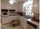 Functional kitchen featuring white cabinets, tile countertops, and essential appliances, offering a blank canvas for upgrades at 1253 Gatewood Drive Dr, Lawrenceville, GA 30043