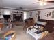 Cozy living room featuring a brick fireplace, ceiling fans, and ample natural light, offering a comfortable living space at 1253 Gatewood Drive Dr, Lawrenceville, GA 30043