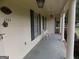 Inviting front porch with columns, white metal chairs and exterior lights, perfect for relaxing outdoors at 1253 Gatewood Drive Dr, Lawrenceville, GA 30043
