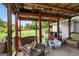 Back porch with wood ceiling supports offering view of large private backyard at 1587 Cronic Town Rd, Auburn, GA 30011