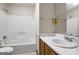 Cozy bathroom featuring a white tub/shower combo with integrated shelving, and a single sink vanity at 1587 Cronic Town Rd, Auburn, GA 30011