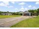 Ranch home with driveway, lush lawn and mature trees at 1587 Cronic Town Rd, Auburn, GA 30011