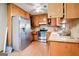 Kitchen featuring stainless steel appliances, light wood cabinets, and durable laminate flooring at 1587 Cronic Town Rd, Auburn, GA 30011