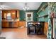 Eat-in kitchen with wood cabinetry, laminate floors, breakfast bar, and natural light from rear door at 1587 Cronic Town Rd, Auburn, GA 30011