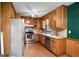 Kitchen featuring stainless steel appliances, wood cabinets, and a ceiling fan for ventilation at 1587 Cronic Town Rd, Auburn, GA 30011