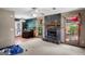 Spacious living room featuring a stone fireplace, ceiling fan, and views to the backyard at 1587 Cronic Town Rd, Auburn, GA 30011