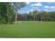 Expansive backyard featuring a lush lawn and mature trees at 3893 Indian Shoals Road, Dacula, GA 30019