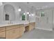 Well-lit bathroom with double sinks, gold fixtures, and glass-enclosed shower at 3893 Indian Shoals Road, Dacula, GA 30019