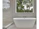 This bathroom showcases a soaking tub with decorative fixtures at 3893 Indian Shoals Road, Dacula, GA 30019
