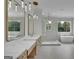 This bathroom boasts a soaking tub, walk-in shower, double vanities, and decorative lighting at 3893 Indian Shoals Road, Dacula, GA 30019
