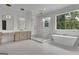 This bathroom boasts a soaking tub, walk-in shower, double vanities, and decorative lighting at 3893 Indian Shoals Road, Dacula, GA 30019