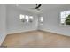 Minimalist bedroom with wood floors, lots of light, white walls, and a modern ceiling fan at 3893 Indian Shoals Road, Dacula, GA 30019