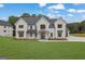 New construction home with painted brick exterior, black trim, and lush green lawn at 3893 Indian Shoals Road, Dacula, GA 30019