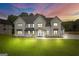 Stunning two-story home featuring a well-manicured lawn and classic architectural details at 3893 Indian Shoals Road, Dacula, GA 30019