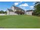 Large, modern home with a well-manicured lawn and a detached guest house at 3893 Indian Shoals Road, Dacula, GA 30019