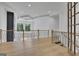Spacious hallway with wood floors, with modern railing, and tray ceilings at 3893 Indian Shoals Road, Dacula, GA 30019
