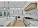 Bright kitchen features white cabinets, a large center island, and stainless steel appliances at 3893 Indian Shoals Road, Dacula, GA 30019