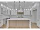 Well-appointed kitchen with white cabinetry, marble countertops, and a center island at 3893 Indian Shoals Road, Dacula, GA 30019