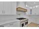 Modern kitchen with white cabinets, quartz countertops, and stainless steel appliances at 3893 Indian Shoals Road, Dacula, GA 30019