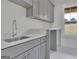 Neutral laundry room with cabinets, sink, and a window view at 3893 Indian Shoals Road, Dacula, GA 30019