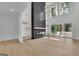 Spacious living room featuring fireplace, hardwood floors, and large windows at 3893 Indian Shoals Road, Dacula, GA 30019