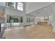 Open-concept living area with hardwood floors, fireplace, and large windows at 3893 Indian Shoals Road, Dacula, GA 30019