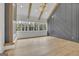 Large main bedroom with fireplace, hardwood floors, accent wall, beamed ceiling and windows at 3893 Indian Shoals Road, Dacula, GA 30019