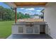 Outdoor kitchen with stainless steel grill and counter space for entertaining at 3893 Indian Shoals Road, Dacula, GA 30019