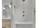 Close-up of the walk-in shower with a built-in bench and a handheld shower head at 3893 Indian Shoals Road, Dacula, GA 30019