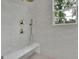 This walk-in shower features a built-in bench and decorative fixtures at 3893 Indian Shoals Road, Dacula, GA 30019