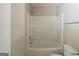 Clean bathroom featuring a shower-tub combo and white fixtures at 5207 Shawn Ln, Stone Mountain, GA 30088
