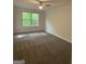 This bedroom is carpeted and has white painted walls and a window with a view at 101 Dancing Fox Rd, Decatur, GA 30032