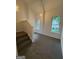 Carpeted hallway and staircase featuring neutral colors and natural lighting at 101 Dancing Fox Rd, Decatur, GA 30032