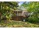 Spacious backyard with a screened porch, a deck, and a lush green lawn, perfect for outdoor enjoyment and relaxation at 1788 River Bluff Vw, Duluth, GA 30097