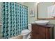 A bathroom featuring a vanity with dark wood, a patterned shower curtain, and tile flooring at 1788 River Bluff Vw, Duluth, GA 30097