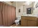 Cozy bathroom with a shower, oak vanity, framed mirror and neutral color palette at 1788 River Bluff Vw, Duluth, GA 30097