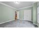 Neutral bedroom featuring light green walls, gray carpet, white trim, and double-door closet at 1788 River Bluff Vw, Duluth, GA 30097
