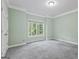 Light-filled bedroom with soft carpet, a large window, and soothing neutral paint at 1788 River Bluff Vw, Duluth, GA 30097