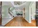 Grand foyer with hardwood floors, a staircase, and views into the living room, creating an open and welcoming space at 1788 River Bluff Vw, Duluth, GA 30097