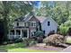 Charming two-story home with stone accents, a welcoming front porch, and beautiful landscaping at 1788 River Bluff Vw, Duluth, GA 30097